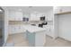 Beautiful kitchen featuring white cabinets, stainless steel appliances, an island and stone countertops at 4629 Alta Dr, Las Vegas, NV 89107