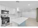 Bright kitchen with white cabinets, stainless steel appliances, an island, and an open layout at 4629 Alta Dr, Las Vegas, NV 89107