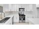 Modern kitchen with stainless steel appliances, white cabinets, sleek countertops and a stainless steel sink at 4629 Alta Dr, Las Vegas, NV 89107