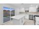 Modern kitchen with stainless steel appliances, an island, and sliding glass doors at 4629 Alta Dr, Las Vegas, NV 89107