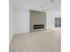 Bright living room with a modern fireplace, wood-look floors, and sliding glass doors at 4629 Alta Dr, Las Vegas, NV 89107