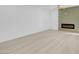 Bright living room with a modern fireplace, wood-look floors, and a neutral color palette at 4629 Alta Dr, Las Vegas, NV 89107
