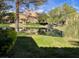 Picturesque backyard with a serene lake, lush greenery, and beautiful landscaping, perfect for relaxation at 5041 Mount Pleasant Ln, Las Vegas, NV 89113