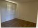 Bedroom with neutral colors, wood flooring, and a window with blinds for privacy at 5041 Mount Pleasant Ln, Las Vegas, NV 89113