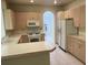 Functional kitchen with ample cabinets, white appliances, and a breakfast bar for casual dining at 5041 Mount Pleasant Ln, Las Vegas, NV 89113