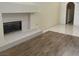 Elegant living room showcases a cozy fireplace with white tile and wood flooring at 5041 Mount Pleasant Ln, Las Vegas, NV 89113