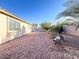 Private backyard with desert landscaping, a bench, and a block wall at 5829 Aqua Verde St, North Las Vegas, NV 89031