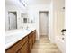Bathroom with double sinks, wood cabinets, and a shower-tub combination at 5829 Aqua Verde St, North Las Vegas, NV 89031