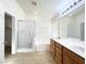 Bathroom featuring double sinks, soaking tub, and a glass-enclosed shower at 5829 Aqua Verde St, North Las Vegas, NV 89031