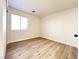 Comfortable bedroom with neutral walls, wood floors, and a closet at 5829 Aqua Verde St, North Las Vegas, NV 89031