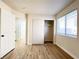 Bedroom featuring wood-look floors, closet, and natural light from the window at 5829 Aqua Verde St, North Las Vegas, NV 89031
