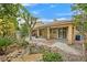 Backyard oasis boasts a pond, mature landscaping, and a covered patio for outdoor entertaining at 5835 Farmhouse Ct, Las Vegas, NV 89141