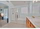 Well-lit bathroom includes double sinks, a shower, and a tub beneath a block window at 5835 Farmhouse Ct, Las Vegas, NV 89141