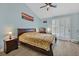 Bright bedroom featuring light blue walls, shuttered windows, and vaulted ceiling with modern ceiling fan at 5835 Farmhouse Ct, Las Vegas, NV 89141