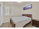 Bedroom featuring a window with blinds and a dark wood bed frame and furniture at 5835 Farmhouse Ct, Las Vegas, NV 89141