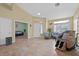 Spacious living room with tile floors and comfortable seating area with natural light at 5835 Farmhouse Ct, Las Vegas, NV 89141