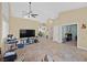 Open-concept living room with tile flooring, neutral walls, and modern ceiling fan at 5835 Farmhouse Ct, Las Vegas, NV 89141