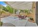 Charming patio area featuring a hot tub, pergola, and outdoor seating, perfect for relaxation at 5835 Farmhouse Ct, Las Vegas, NV 89141