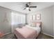 Bedroom features a pink bed, modern décor, and a window at 6121 Dayton Cir, Las Vegas, NV 89107