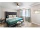 Bedroom features a tufted headboard and neutral decor, creating a relaxing space at 6121 Dayton Cir, Las Vegas, NV 89107