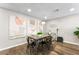 Bright dining room with contemporary artwork, modern lighting, and hardwood flooring at 6121 Dayton Cir, Las Vegas, NV 89107
