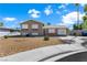 Charming two-story home featuring well-maintained landscaping and a spacious driveway at 6121 Dayton Cir, Las Vegas, NV 89107