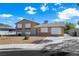Two-story home with a brick-accented front and a gravel yard and driveway at 6121 Dayton Cir, Las Vegas, NV 89107