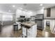 Bright kitchen features an island with breakfast bar, stainless steel appliances, and white cabinetry at 6121 Dayton Cir, Las Vegas, NV 89107