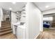 Bright laundry room with modern appliances, open shelving, and easy access to the bedroom at 6121 Dayton Cir, Las Vegas, NV 89107