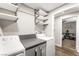 Functional laundry room with shelving, countertop, and access to another room at 6121 Dayton Cir, Las Vegas, NV 89107
