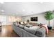 Comfortable living room with a large sofa, modern decor, and hardwood flooring at 6121 Dayton Cir, Las Vegas, NV 89107
