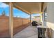 Inviting covered patio, complete with a grill, seating, and a brick wall, perfect for outdoor relaxation and entertaining at 6461 Karlsen Ct, Las Vegas, NV 89122