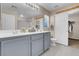 Double sink bathroom with gray cabinets, bright lighting and tile flooring at 6461 Karlsen Ct, Las Vegas, NV 89122