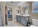 Modern bathroom with double sink vanity, a large mirror, and neutral color scheme at 6461 Karlsen Ct, Las Vegas, NV 89122
