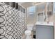 Well-lit bathroom with modern vanity, toilet, and shower boasting a patterned curtain for added style and privacy at 6461 Karlsen Ct, Las Vegas, NV 89122