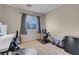 Comfortable bedroom providing space for work with desks and chairs, complemented by a compact refrigerator at 6461 Karlsen Ct, Las Vegas, NV 89122