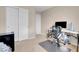 Relaxing bedroom showing closet, chair, carpet, desk and large monitor: perfect for work or enjoying media at 6461 Karlsen Ct, Las Vegas, NV 89122