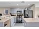 Bright kitchen features stainless appliances, breakfast bar, and ample cabinet space for storage at 6461 Karlsen Ct, Las Vegas, NV 89122
