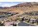View of desert homes near mountain showcasing modern architecture, landscaping, and walking paths at 6491 Wild Blue Ct, Las Vegas, NV 89135
