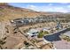Desert homes nestled by a mountain with lush landscaping, sidewalks and a scenic neighborhood layout at 6491 Wild Blue Ct, Las Vegas, NV 89135
