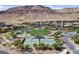 Community aerial view featuring a park, tennis courts, walking paths, and luxury desert homes at 6491 Wild Blue Ct, Las Vegas, NV 89135