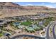 Community aerial view featuring a park, tennis courts, walking paths, and luxury desert homes at 6491 Wild Blue Ct, Las Vegas, NV 89135