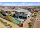 Expansive aerial view of a modern home with a sparkling pool and well-manicured landscaping at 6491 Wild Blue Ct, Las Vegas, NV 89135