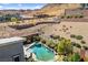 An aerial perspective showcases the stunning pool, spa, and terraced landscaping against a desert mountain backdrop at 6491 Wild Blue Ct, Las Vegas, NV 89135