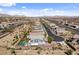 Aerial view of modern homes in desert community, showcasing landscaping and mountain views under a bright sky at 6491 Wild Blue Ct, Las Vegas, NV 89135