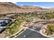 Community aerial view showcasing lush landscaping, walking paths, and nearby desert mountains at 6491 Wild Blue Ct, Las Vegas, NV 89135
