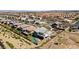 Expansive aerial view of a desert neighborhood with modern homes, landscaping, and distant city skyline at 6491 Wild Blue Ct, Las Vegas, NV 89135