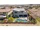 Beautiful backyard with a pool, spa, and lounge area in a modern home, aerial view at 6491 Wild Blue Ct, Las Vegas, NV 89135