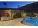 Backyard with a built-in BBQ, outdoor lighting, brick walls, and a beautiful pool at 6491 Wild Blue Ct, Las Vegas, NV 89135