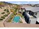 Aerial view of a backyard showcasing a pool, spa, patio, outdoor kitchen, and desert landscaping at 6491 Wild Blue Ct, Las Vegas, NV 89135